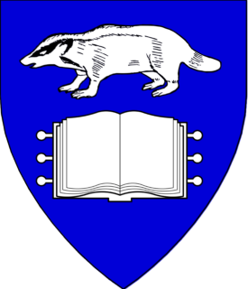 Azure, in pale a brock statant and an open book argent.